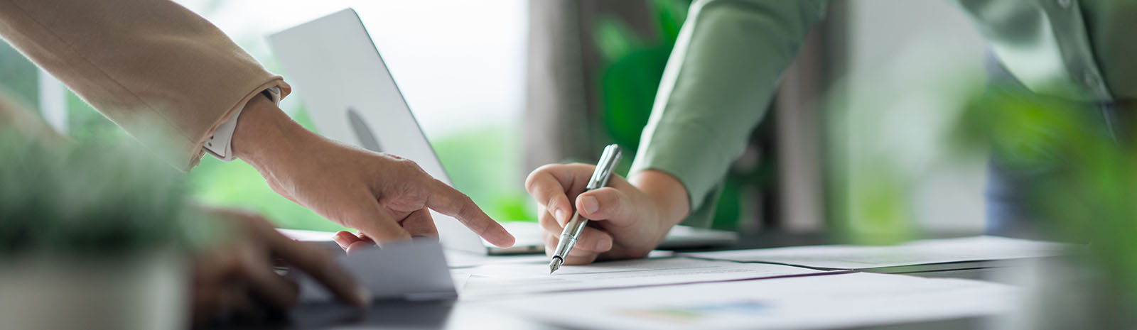 Man and woman pointing at business documents on desk