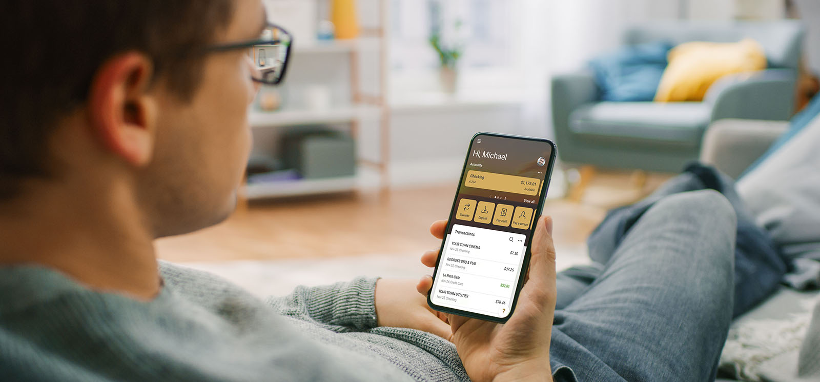 Man relaxing at home using CSB mobile banking app
