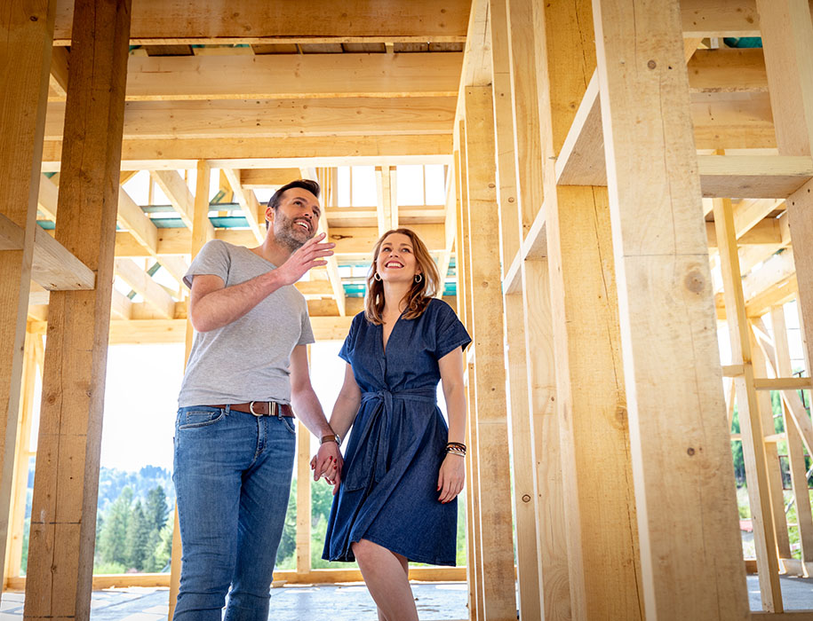 Couple holding hands at home construction site